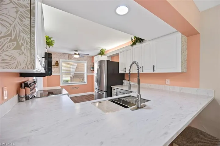 Eat-at kitchen bar with new countertops and large stainless sink
