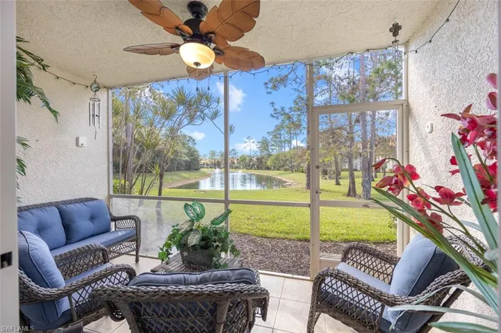 Sunroom / solarium featuring a water view and ceiling fan