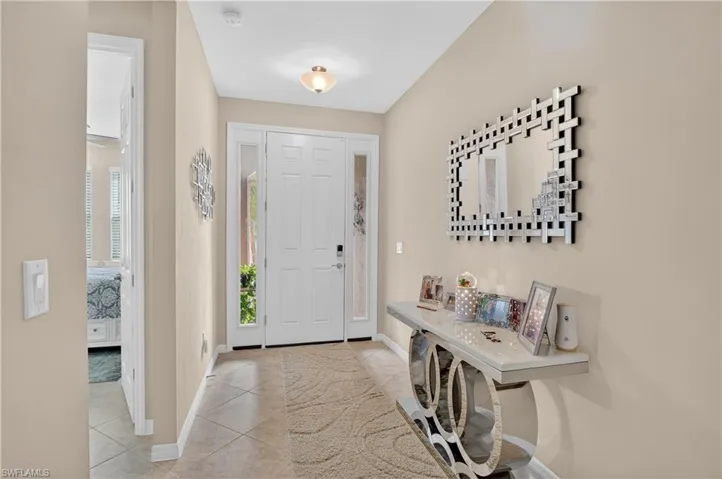 Foyer featuring baseboards and light tile patterned flooring