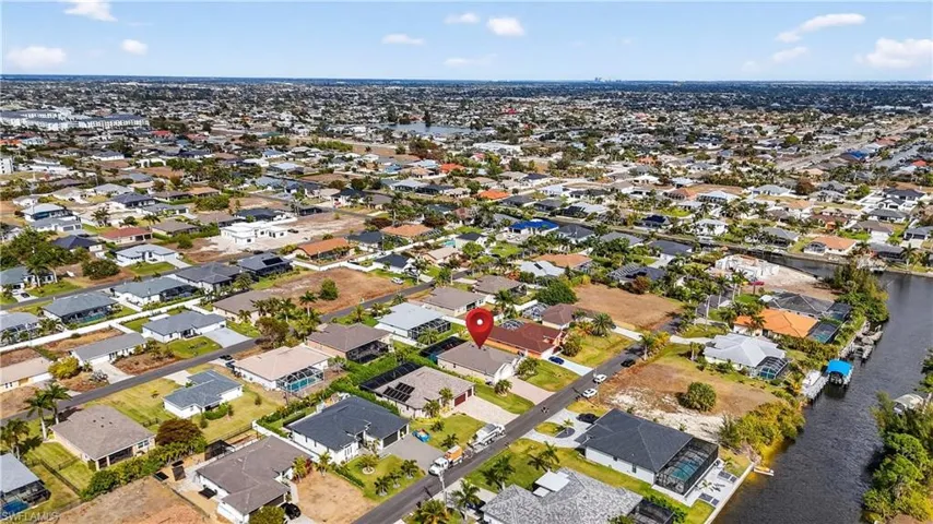 Aerial view of property's location with nearby suburban area