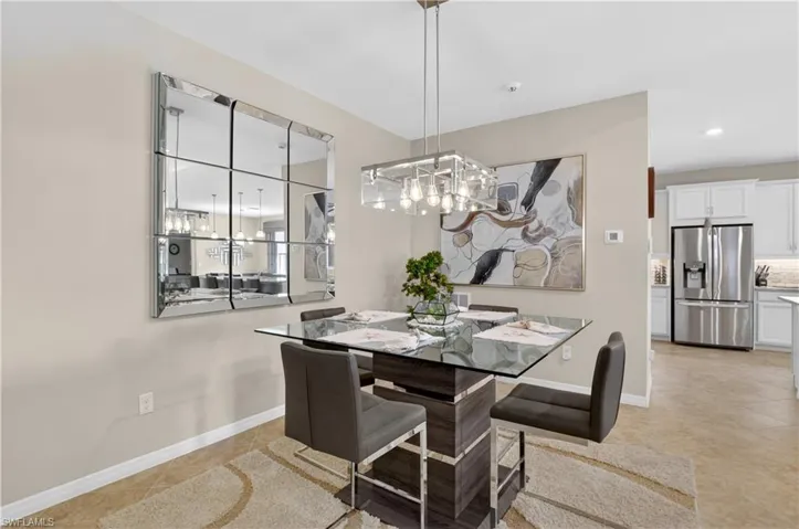 Dining area with light tile patterned floors and hanging lights