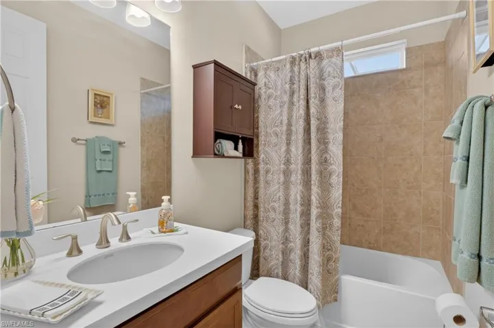 Bathroom with vanity and shower / tub combo with curtain