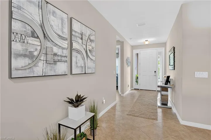 Foyer featuring baseboards and light tile patterned floors