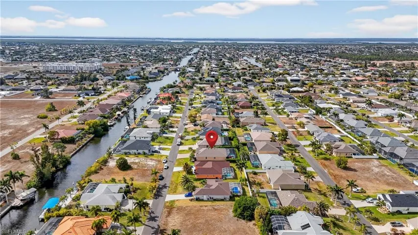 Aerial view of property's location featuring nearby suburban area and a large body of water