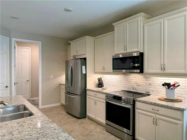 Dining area with light tile patterned floors and hanging lights