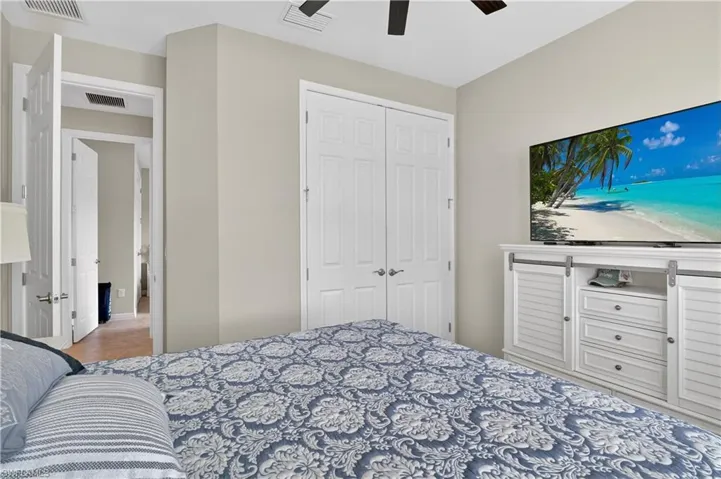 Bedroom featuring ceiling fan and a closet