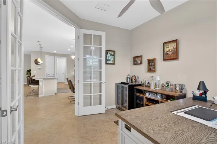 Office area with french doors, bar, ceiling fan, recessed lighting, and light tile patterned floors