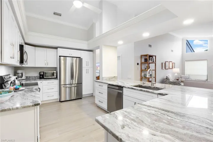 Crown Moldings, Soft Close Wood Cabinetry, Pull Outs, New SS Appliances, Large Bay Sink, Granite