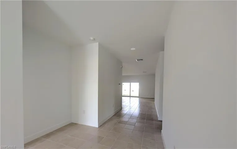 Hall featuring light tile patterned floors and recessed lighting
