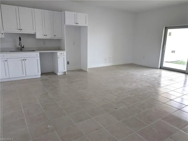 Kitchen featuring white cabinets, light countertops, and light tile patterned floors