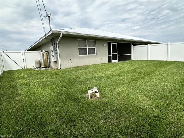 2306 view from SW corner of canopied water treatment system/storage/fenced gate