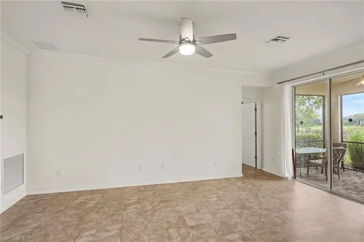 Spacious room with tile flooring, crown molding, and a ceiling fan with integrated lighting