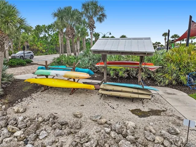 Palm trees and lush landscaping surround the property's recreational storage area
