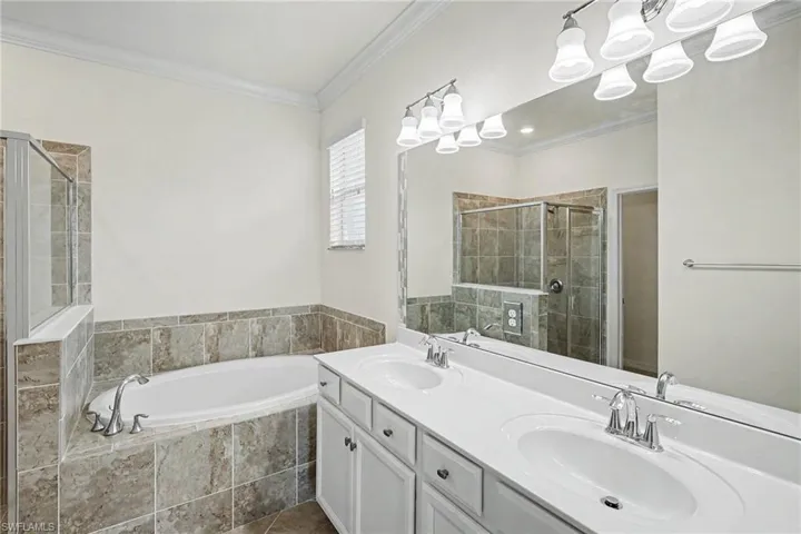 Dual vanity with undermount sinks, chrome fixtures, and a large mirror