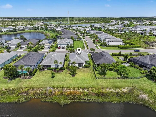 Aerial perspective showcasing a residential community with water features and established landscaping