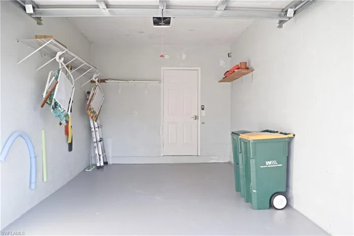 Garage featuring concrete block wall
