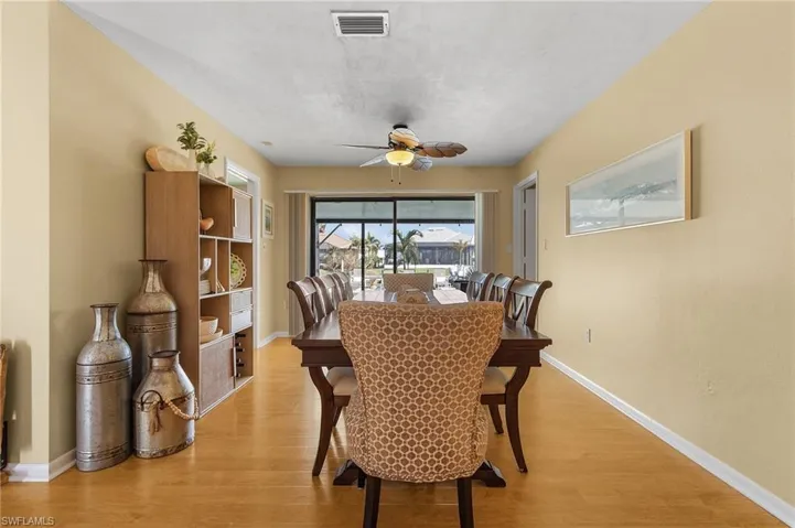 Dining room with light wood-type flooring and ceiling fan