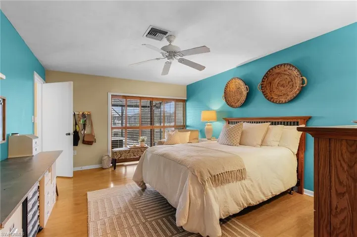 Bedroom with light hardwood / wood-style floors and ceiling fan