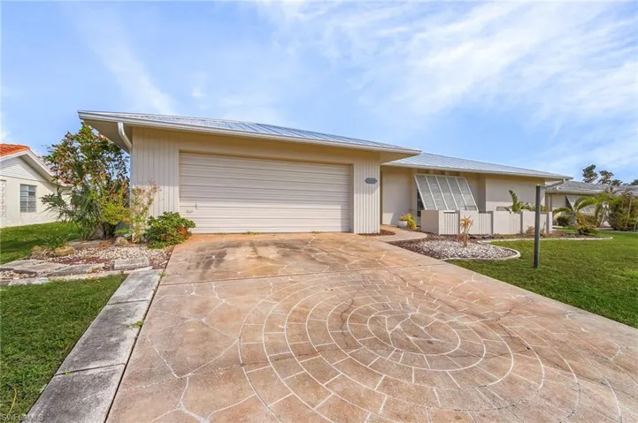 View of front of house with a front lawn and a garage