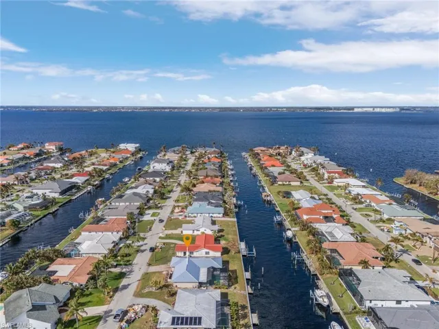 Birds eye view of property with a water view