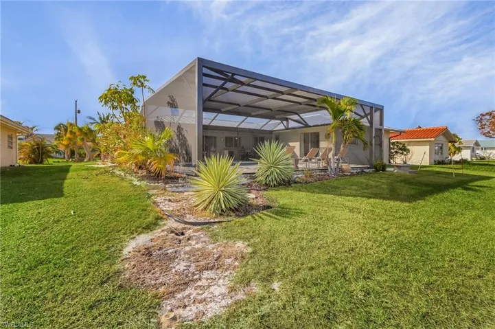 View of yard featuring a patio and glass enclosure