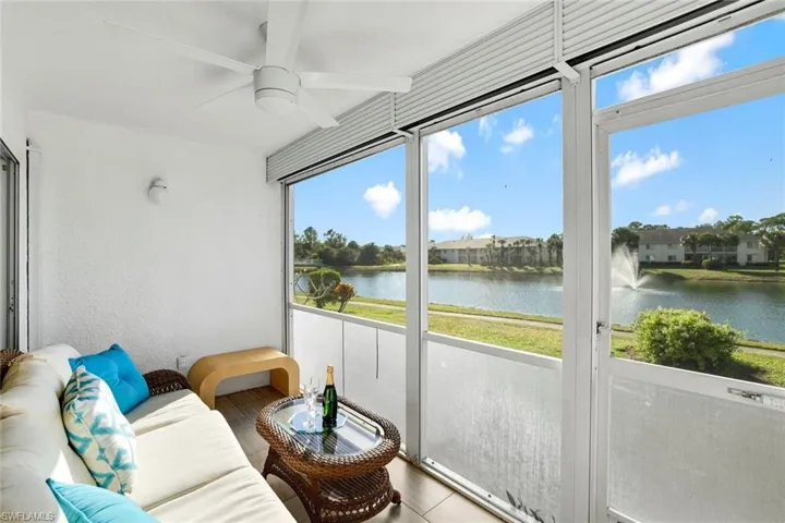 Sunroom featuring ceiling fan and a water view