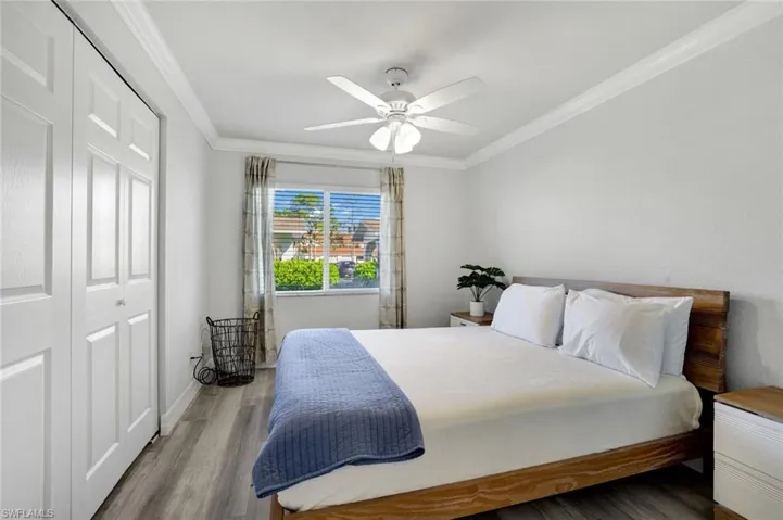 Bedroom #2 featuring Cortex vinyl flooring, a closet, ceiling fan, and ornamental molding