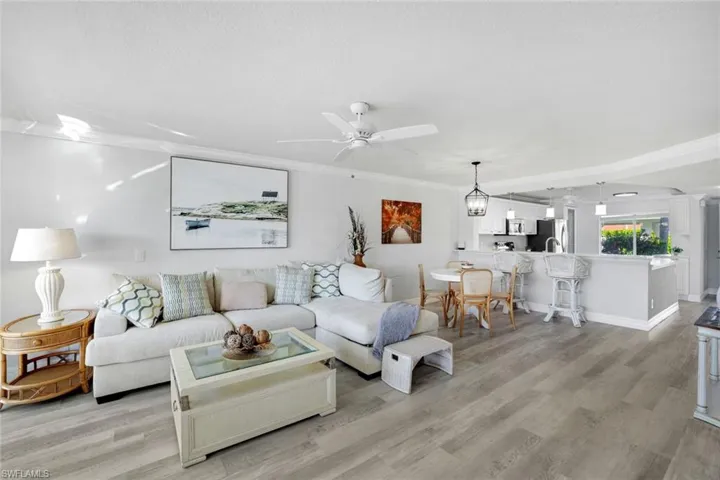 Dining space featuring crown molding, lCoretex vinyl flooring, and light fixture.