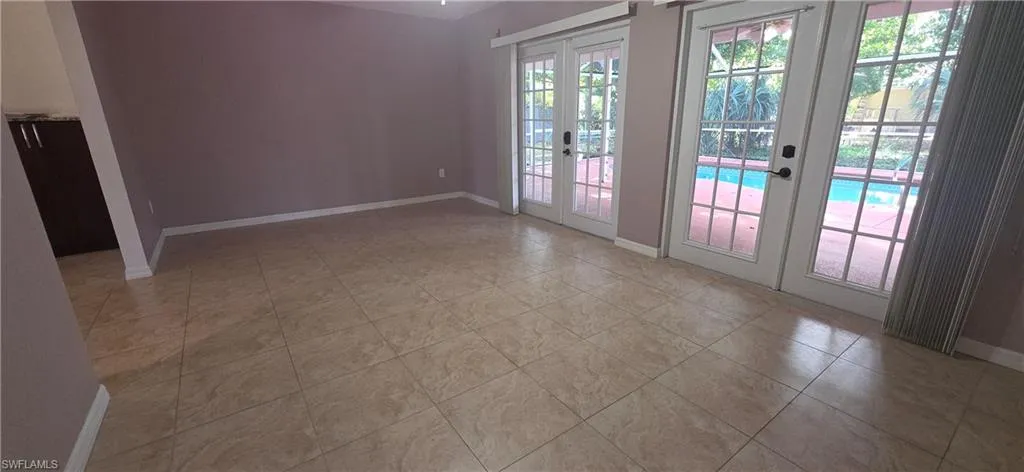 Doorway to outside with french doors and tile patterned floors
