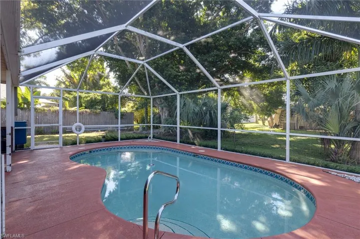 View of swimming pool with a lanai and a sunroom