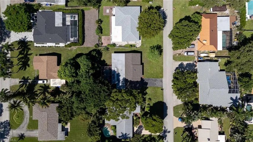 Aerial view of property and surrounding area with nearby suburban area