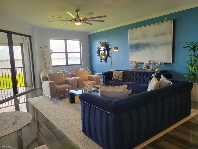 Living area with crown molding, wood finished floors, and a ceiling fan