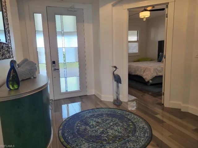 Doorway to outside with baseboards and wood finished floors