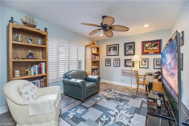 Bedroom with dark wood-type flooring, a ceiling fan, and recessed lighting