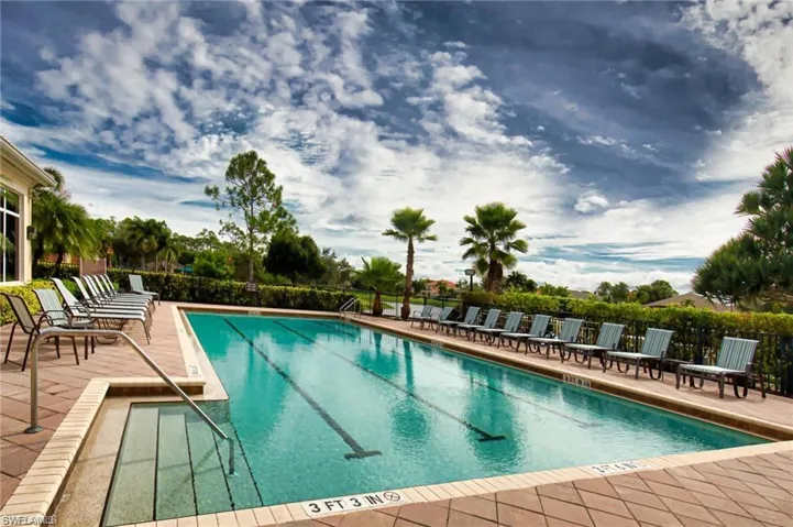 Community pool with a patio