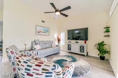 Living area featuring light wood-style flooring and a ceiling fan