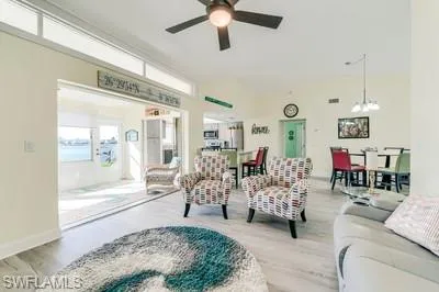 Living room with wood finished floors and ceiling fan