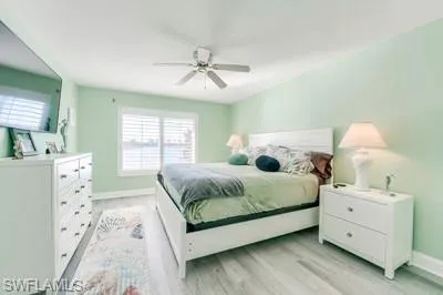 Bedroom with light wood-type flooring and a ceiling fan