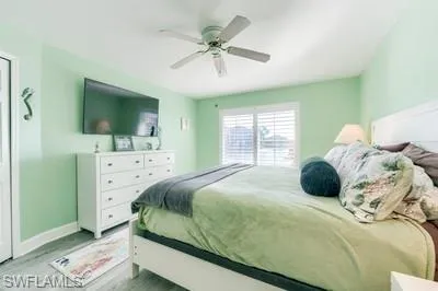Bedroom with ceiling fan and wood finished floors