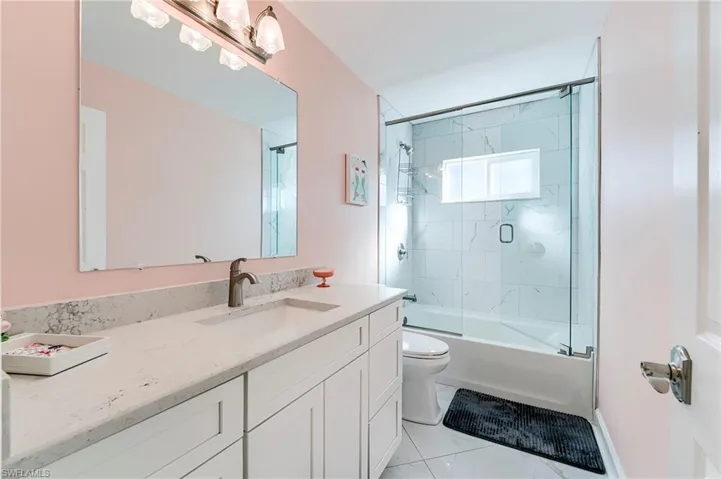 Full bathroom featuring combined bath / shower with glass door and vanity