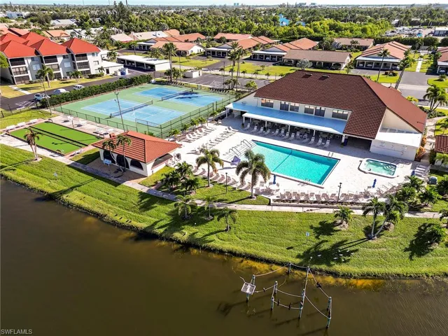 Aerial overview of property's location with nearby suburban area and a nearby body of water