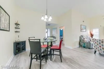Dining space featuring light wood-style floors and a chandelier