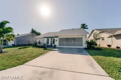 Ranch-style home with a front lawn and concrete driveway