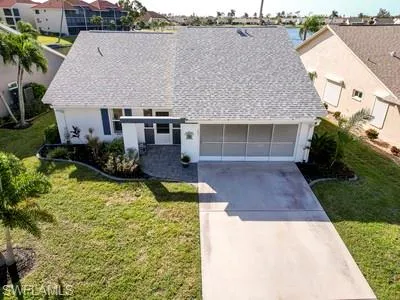 View of front of house featuring driveway, a garage, a residential view, and stucco siding