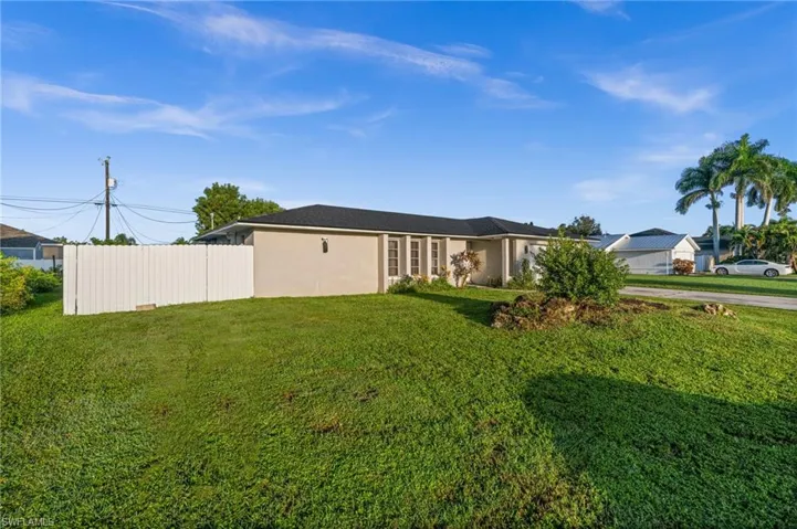 View of side of property featuring a garage and concrete driveway