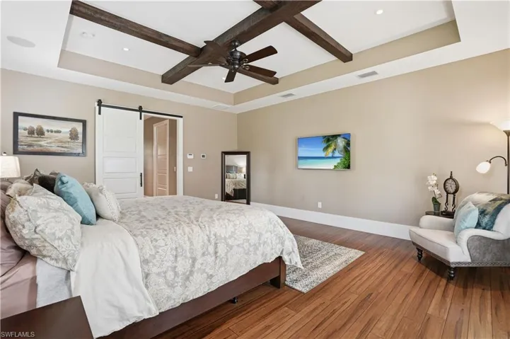 The primary suite allows access to the lanai area.