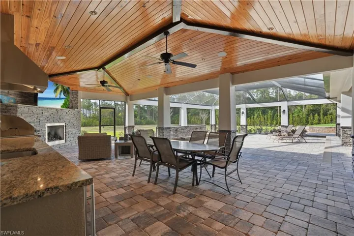 Spacious outdoor area with kitchen, fireplace, OVERSIZED hot tub and plenty of seating.