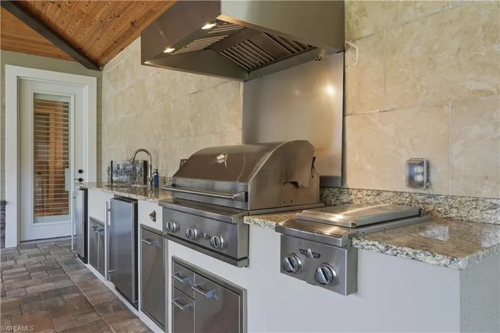 Cook outdoors year round with this fully equipped kitchen!