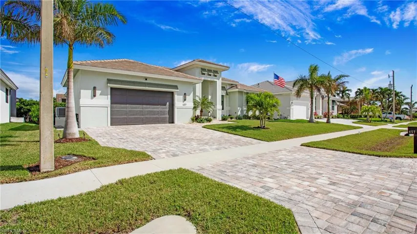 View of front of property with a garage and a front yard