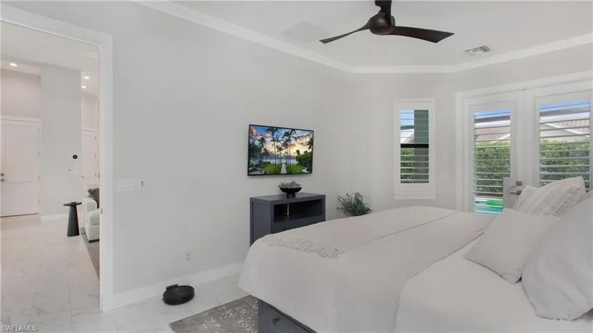 Bedroom with access to outside, ceiling fan, and ornamental molding